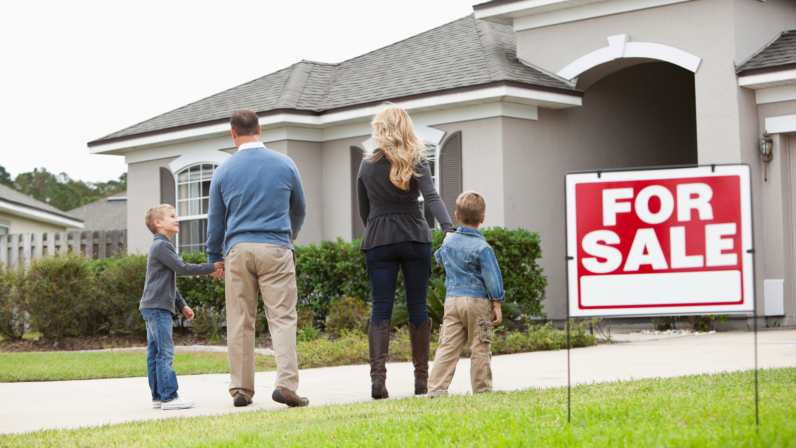 A family confidently putting a FSBO sign in their yard because they have help from Florida FSBO Realty, Inc.